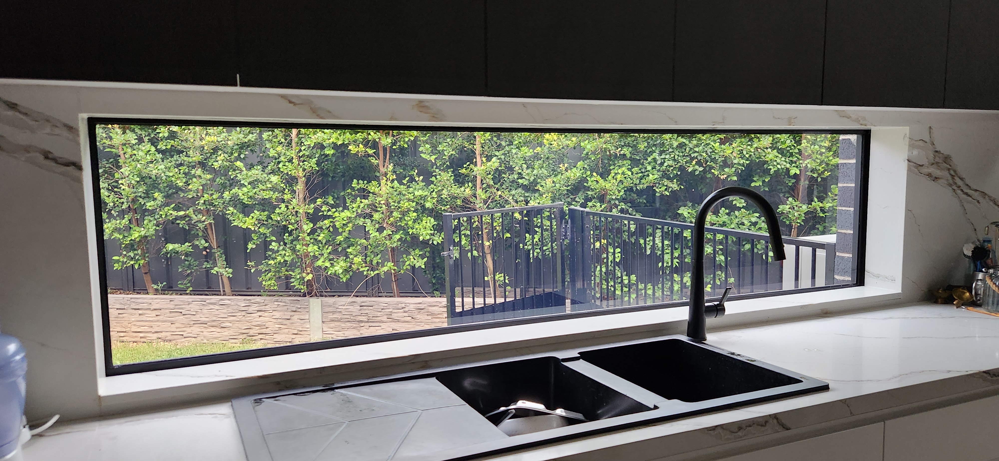 kitchen skinny long splashback  window tinted inside view shows no glare and heat aswel as optical clarity viewing outside after window tint installed perfect clean custom install no gaps just how its meant to be installed 